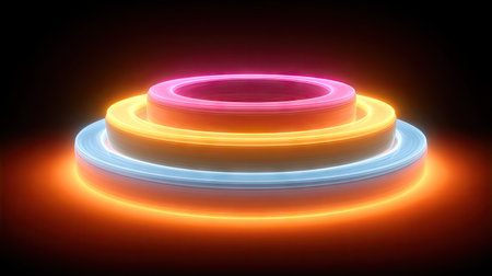 A vibrant digital rendering showcases a circular design with multiple neon rings. The image displays a gradient of colors from pink to orange and blue, set against a dark backdrop. This composition utilizes dynamic lighting and a modern aesthetic, suitable for use in various visual projects, including website design or promotional materials.の素材