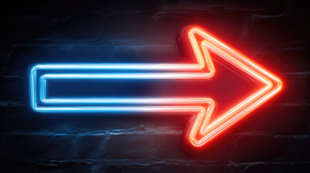 A vibrant neon arrow sign, glowing with red and blue light, is mounted on a textured brick wall. The image showcases a modern aesthetic, with a play of colors and shadows, and the lighting enhancing its three-dimensional quality. This could be useful in graphic design or presentations.の素材