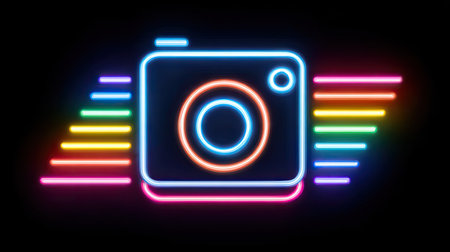 A vibrant neon sign showcases a camera symbol, outlined with bright blue and orange lights, accompanied by colorful rainbow wings. The graphic style employs a modern, digital aesthetic, set against a dark background that enhances the luminosity. Suitable for diverse applications, including creative projects and digital media.の素材