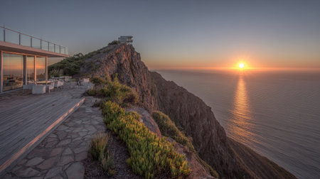 An overhead perspective captures a scenic sunset with the ocean and a coastal cliff. The composition highlights the skyの素材