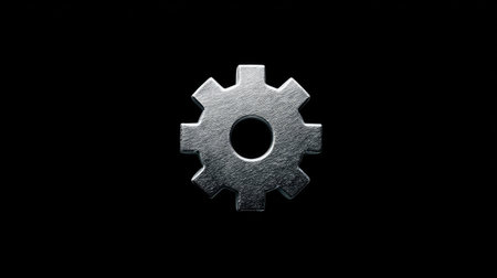 Metal gear wheel isolated on a black background. Close-up.の素材