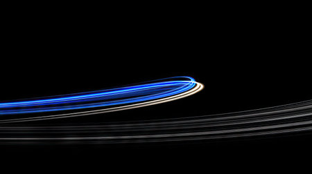 Abstract image showcases curved light trails in shades of blue and white against a black backdrop. The streaks create a sense of movement and energy, employing a minimalist style with a focus on lines and shapes. Suitable for conceptual designs, this image could be used in various commercial projects.の素材