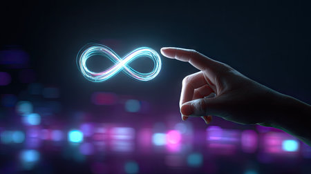 A hand delicately interacts with a luminous infinity symbol against a dark background with blurred bokeh lights. The image features a cool color palette with shades of blue and purple. The composition is close-up, focusing on the symbol and hand. This image could be suitable for use in various commercial and editorial projects.の素材