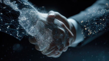 Two hands clasp in a gesture of agreement, overlaid with a network of digital connections. The image features cool tones and sharp focus, with elements suggesting global connectivity. This composition is suitable for illustrating concepts of teamwork, technology, or international business, adaptable for diverse commercial uses.の素材