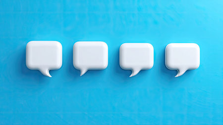 Four white, 3D-rendered speech bubbles are neatly aligned against a solid blue backdrop. The objects are smooth and uniform, implying a digital or design-focused context. The lighting is even, suggesting an artificial source. This image could be used for conceptual illustrations related to conversation or dialogue.の素材