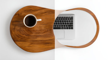 A top-down shot presents a coffee cup and a laptop on a dual-surface tray against a stark white backdrop. The tray is half wood, half white, with the laptop placed on the right side. The scene highlights the contrasting textures and colors, suggesting potential uses in advertising or editorial content, emphasizing workspace or leisure.の素材