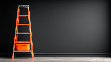 An orange ladder leans against a dark wall, with an orange container resting on the lower step. The image presents a minimalist composition, featuring strong contrast and a sense of depth. The lighting highlights the textures. Suitable for illustrating concepts related to work and construction.の素材