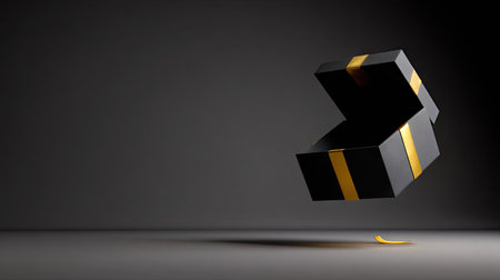 A black gift box with gold ribbon floats against a dark gray background. The composition shows an open box, suggesting a reveal or present. The lighting is soft, highlighting the box's texture, and the style is minimalist with copy space. Suitable for advertising or promotional material.の素材