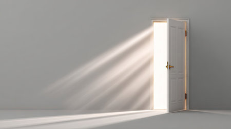 An open door reveals a burst of light flooding into a stark, minimalist interior. The image showcases the interplay of light and shadow, highlighting the door's structure against a plain wall. The scene could be used for various commercial or editorial applications. The composition emphasizes simplicity and visual impact.の素材