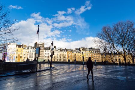 Man cross a street in Paris back light landscapeのeditorial素材