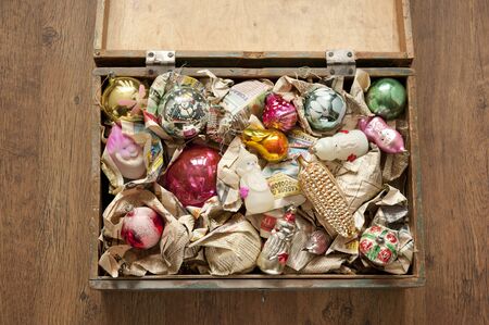 wooden box of old Christmas toys wrapped in newspaperの写真素材