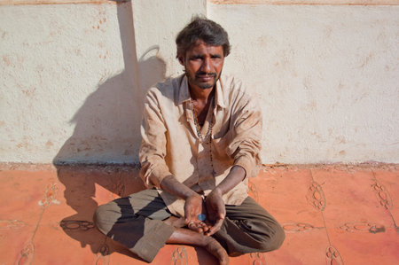 the beggar asks for alms in Old Goa near church