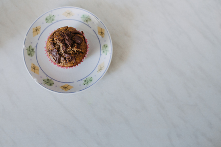 carob muffin on a white plate in minimalistic compositionの写真素材