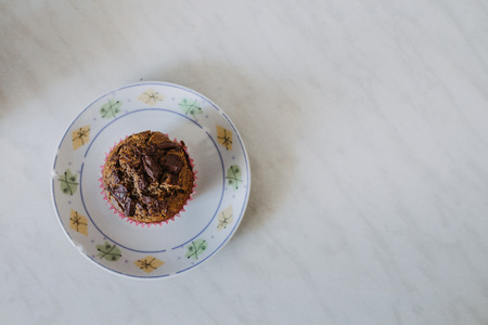 carob muffin on a white plate in minimalistic compositionの写真素材