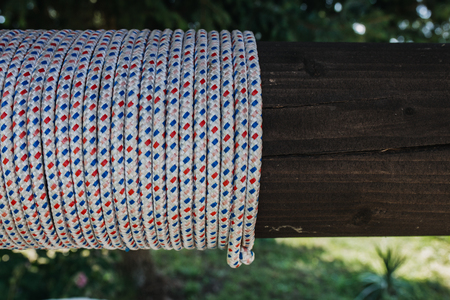 rope with dots tied around woodの写真素材