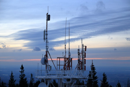 Telecommunication tower at sunset in the mountains, telecommunication concept.