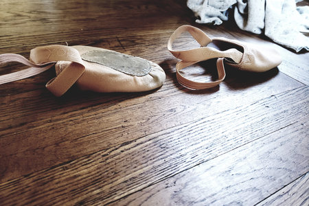 Ballet shoes on hardwood.