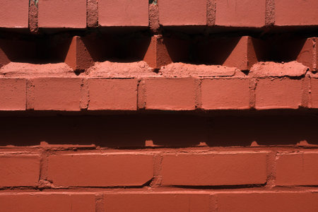 Brick wall. Soft wall. Wall made of cement and brick. A wall in the sunlightの写真素材