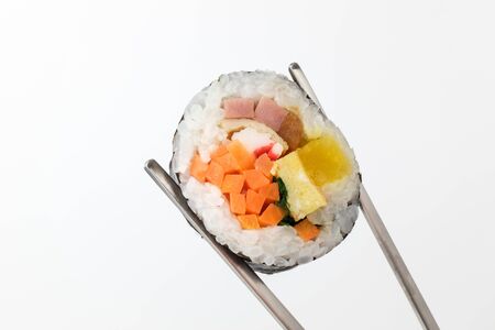 Food with vegetables and rice. Rice wrapped with seaweed. Food with vegetables and hamの写真素材