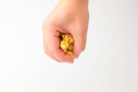caramel popcorn hold on handの写真素材