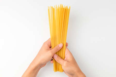 Italian pasta noodles. Flat and thin pasta. Yellow linguini pastaの写真素材