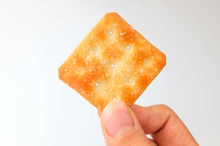 Crackers in square shape. Dessert coated with sugar. Crunchy snackの写真素材