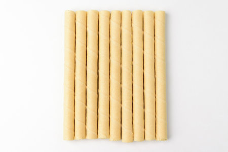 Wafer Roll with Vanilla Cream. Crunchy sweet dessert. Elongated vanilla snack