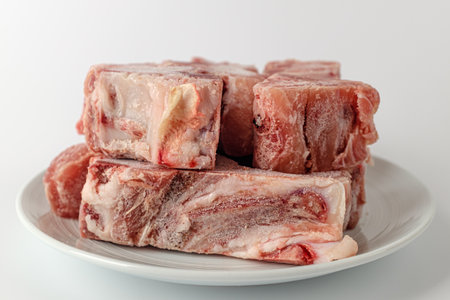 a piece of pork bone. bones with meat. frozen meatの写真素材