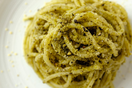 italian food culture. Spaghetti Seasoned with Basil Pesto. Food with basil, cheese, olive oil and...