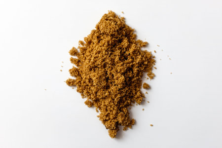 Dark brown sugar on a white background