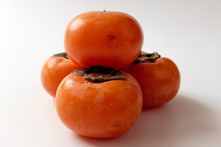 ripe persimmon on a white backgroundの写真素材