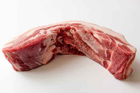 Whole pork belly on a white background