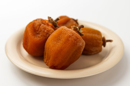 Half dried persimmon on a white backgroundの写真素材