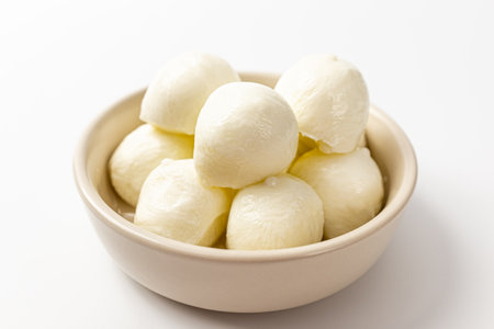 Mozzarella pearls cheese on white backgroundの写真素材