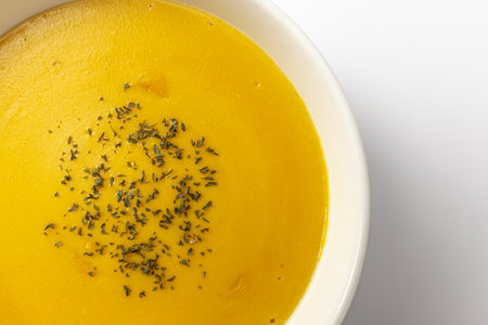 Sweet pumpkin soup on a white backgroundの写真素材