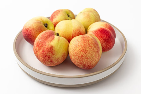 white peaches without hairs on a white backgroundの写真素材