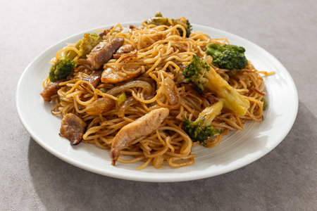 Stir-fried Hong Kong-style egg noodles with meat and vegetablesの写真素材