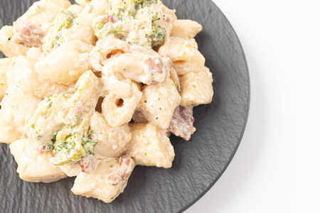 Cream Tteokbokki Korean Rice Cake with Bacon and Broccoli on White Backgroundの写真素材