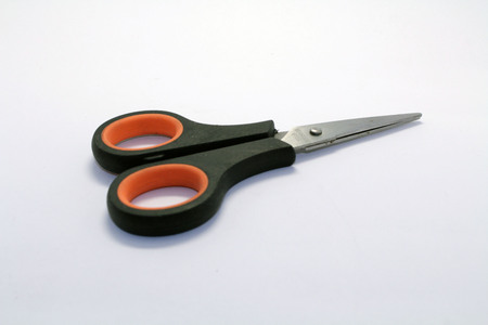 The scissors, a black one with some orange strip. A trivial but essential stationery.の写真素材