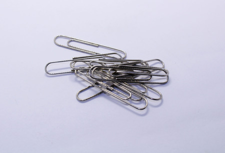A pile of paper clip or paperclip, used to hold sheets together. Made of wire.の写真素材