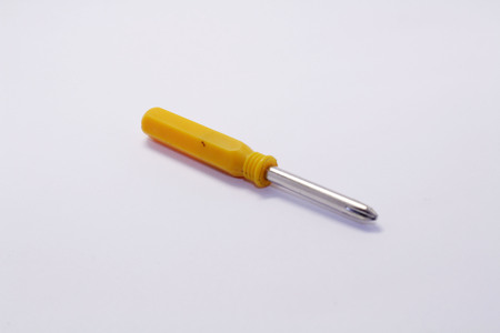The yellow screwdriver, used for screwing and unscrewing. Useful.の写真素材
