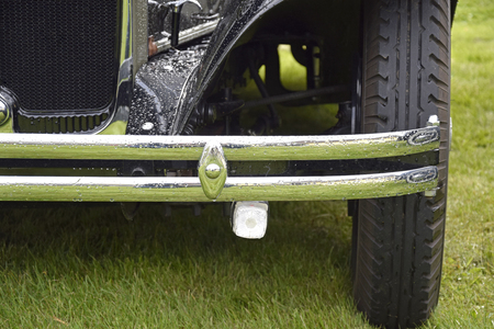 The front wheel of an old car that is all polished upの写真素材