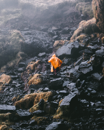 Yellow Raincoat on Rocksの写真素材
