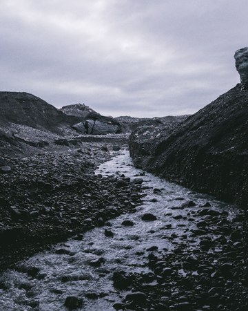Frozen River Leading to Rocksの写真素材