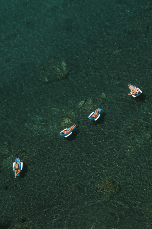 People Relaxing on Emerald Waterの写真素材