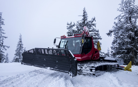 Piste Machine before snow-covered treesの写真素材