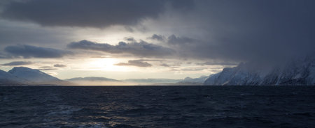 Sunlight trough the clouds at kvaenangen in Norway