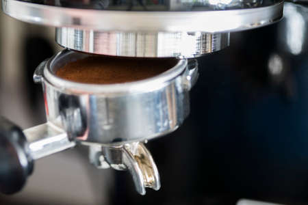 Fresh grinder cafe beans in a pistonの写真素材