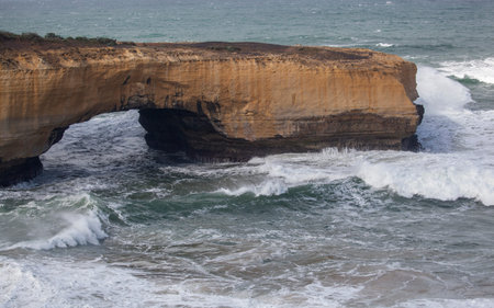 Waves crashing on cliffs of London Bridge at the great ocean road, Australia