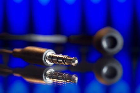 plug the headphones close-up on a dark backgroundの写真素材